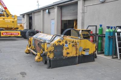 image showing a large yellow on-track machine