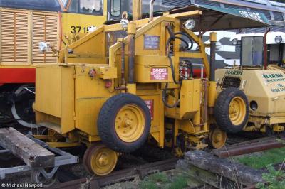 image showing a large yellow on-track machine