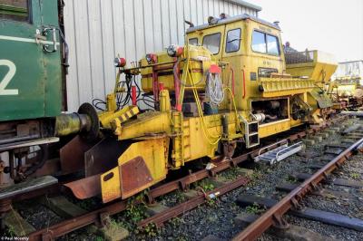 image showing a large yellow on-track machine