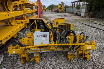 image showing a large yellow on-track machine