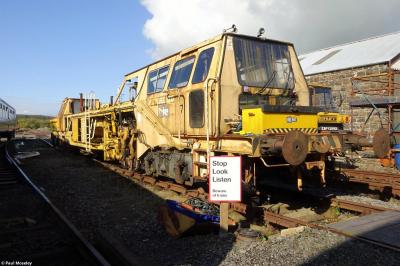 image showing a large yellow on-track machine
