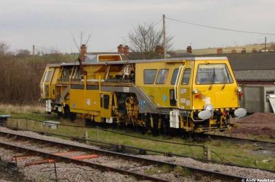 image showing a large yellow on-track machine