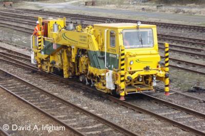 image showing a large yellow on-track machine