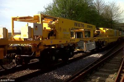 image showing a large yellow on-track machine