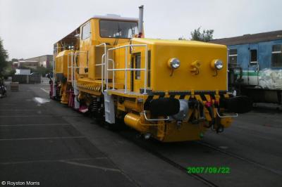 image showing a large yellow on-track machine