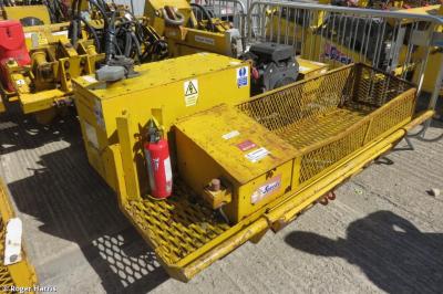 image showing a large yellow on-track machine