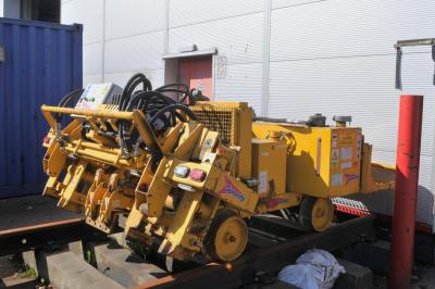 image showing a large yellow on-track machine