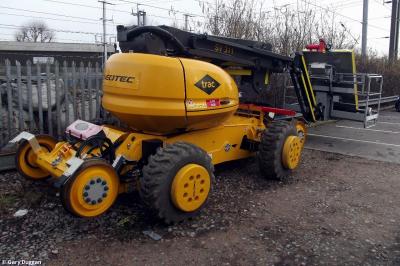 image showing a large yellow on-track machine