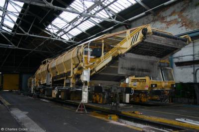 image showing a large yellow on-track machine