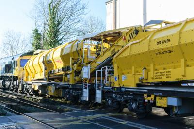 image showing a large yellow on-track machine