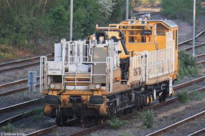image showing a large yellow on-track machine