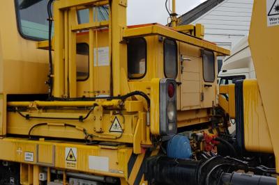 image showing a large yellow on-track machine