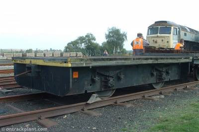 image showing a large yellow on-track machine