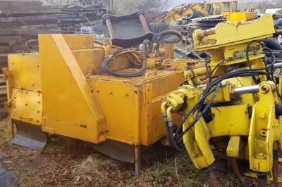 image showing a large yellow on-track machine