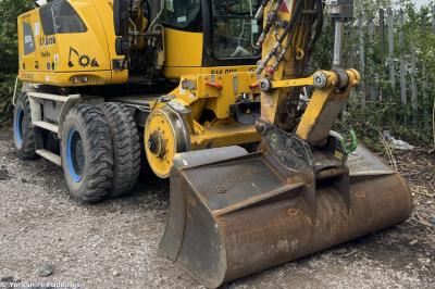 image showing a large yellow on-track machine