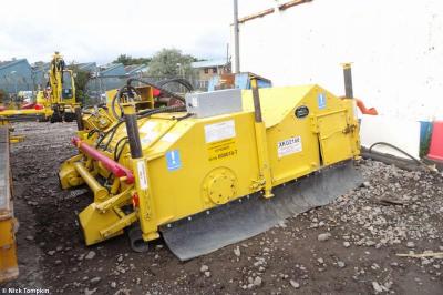 image showing a large yellow on-track machine