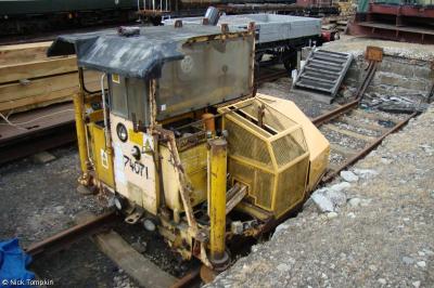 image showing a large yellow on-track machine