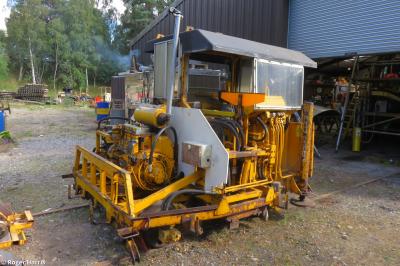image showing a large yellow on-track machine