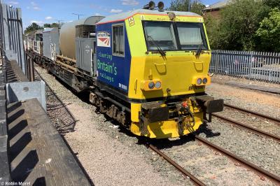 image showing a large yellow on-track machine
