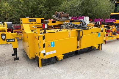 image showing a large yellow on-track machine