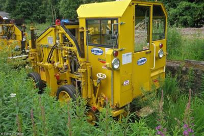image showing a large yellow on-track machine