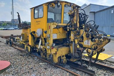 image showing a large yellow on-track machine
