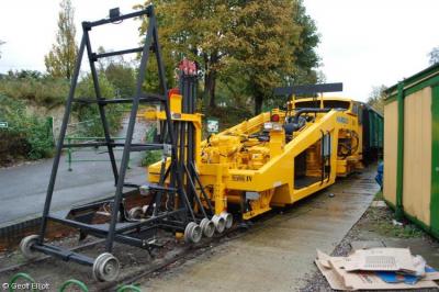 image showing a large yellow on-track machine