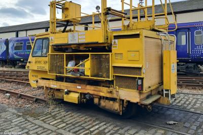 image showing a large yellow on-track machine