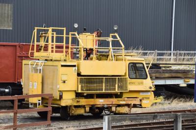 image showing a large yellow on-track machine