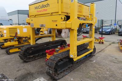 image showing a large yellow on-track machine
