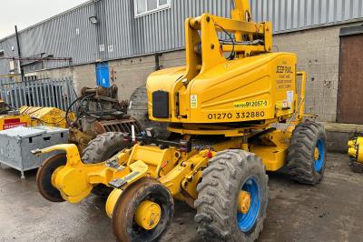 image showing a large yellow on-track machine