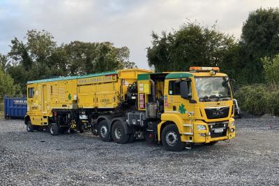 image showing a large yellow on-track machine