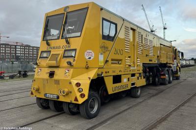image showing a large yellow on-track machine