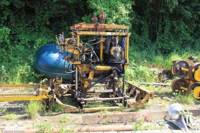 image showing a large yellow on-track machine