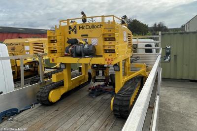 image showing a large yellow on-track machine