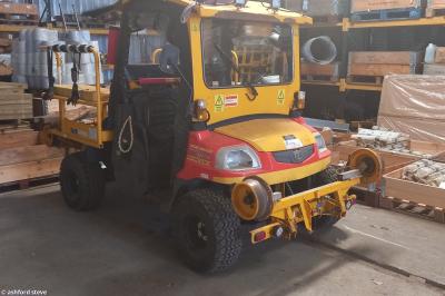 image showing a large yellow on-track machine
