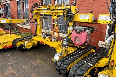 image showing a large yellow on-track machine