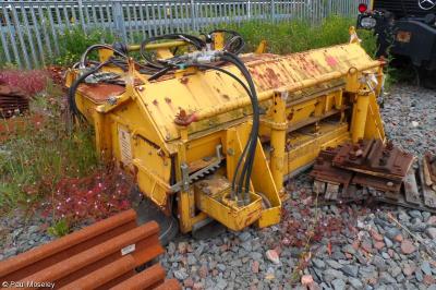 image showing a large yellow on-track machine