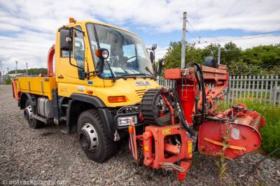 image showing a large yellow on-track machine