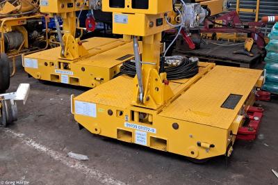 image showing a large yellow on-track machine