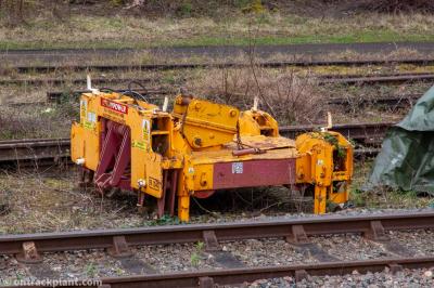 image showing a large yellow on-track machine