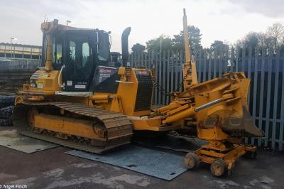 image showing a large yellow on-track machine