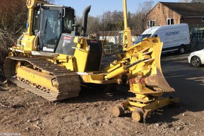 image showing a large yellow on-track machine