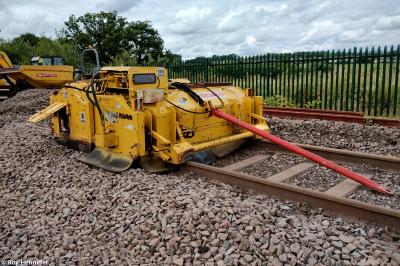 image showing a large yellow on-track machine