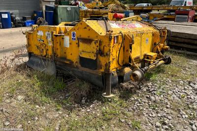 image showing a large yellow on-track machine