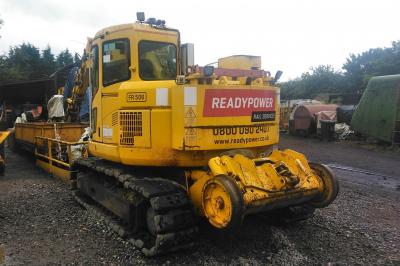 image showing a large yellow on-track machine