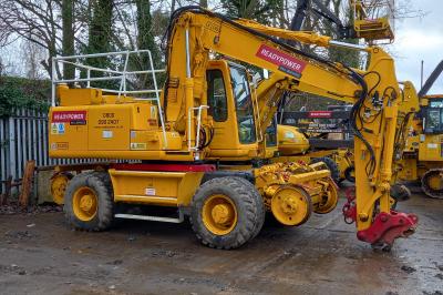 image showing a large yellow on-track machine