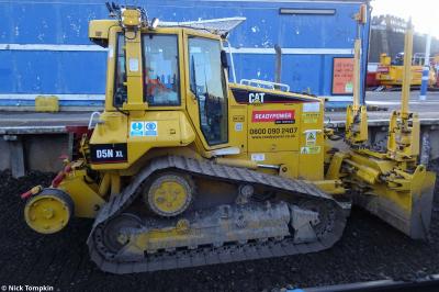 image showing a large yellow on-track machine