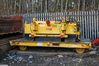 image showing a large yellow on-track machine