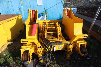 image showing a large yellow on-track machine
